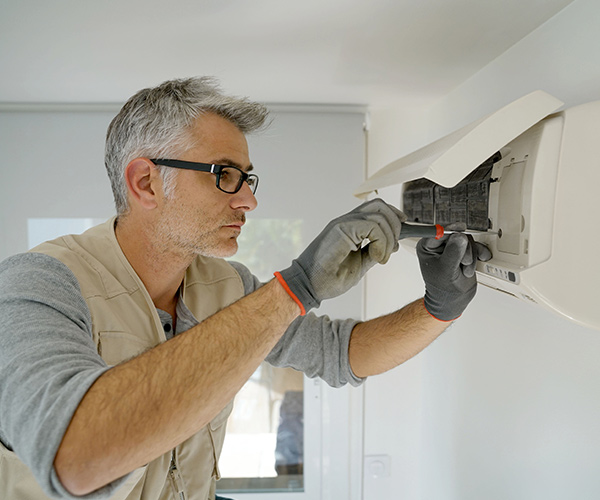 Photo of a man replacing air filters